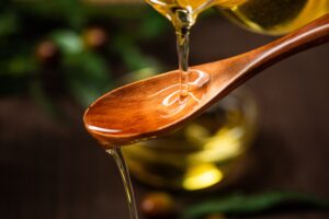 spoon pouring olive oil